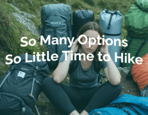 photograph of a beautiful irish girl with a look of confusion on her face with a pile of camping gear With Text