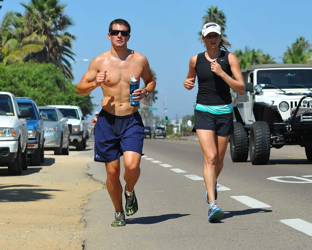 Running Styles - a man and woman running down a street